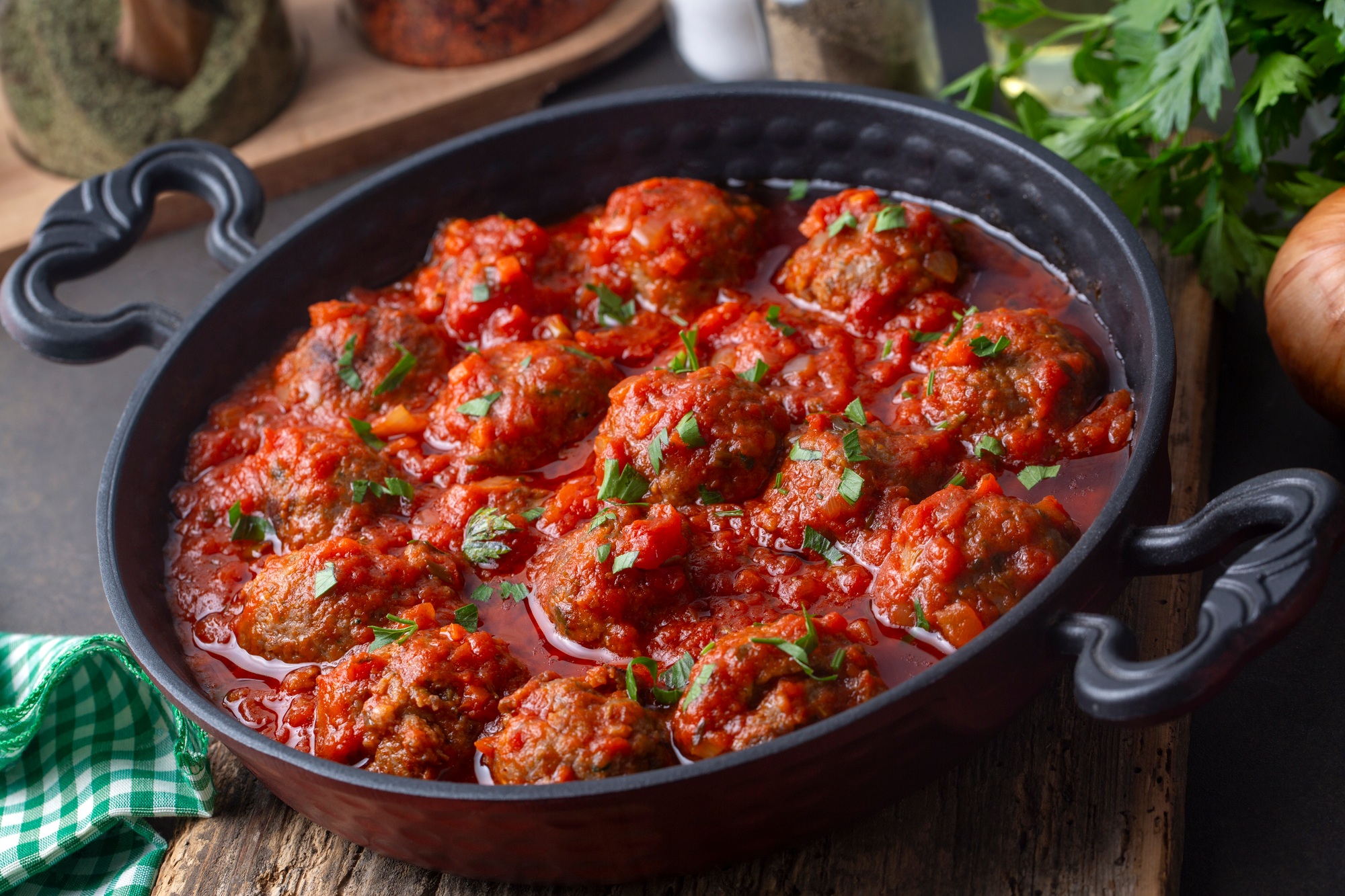 Delicious fresh meatballs in tomato sauce with salt, spices and herbs